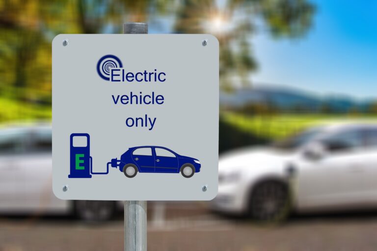 Used electric car charging while a buyer evaluates whether the low price is a good deal.